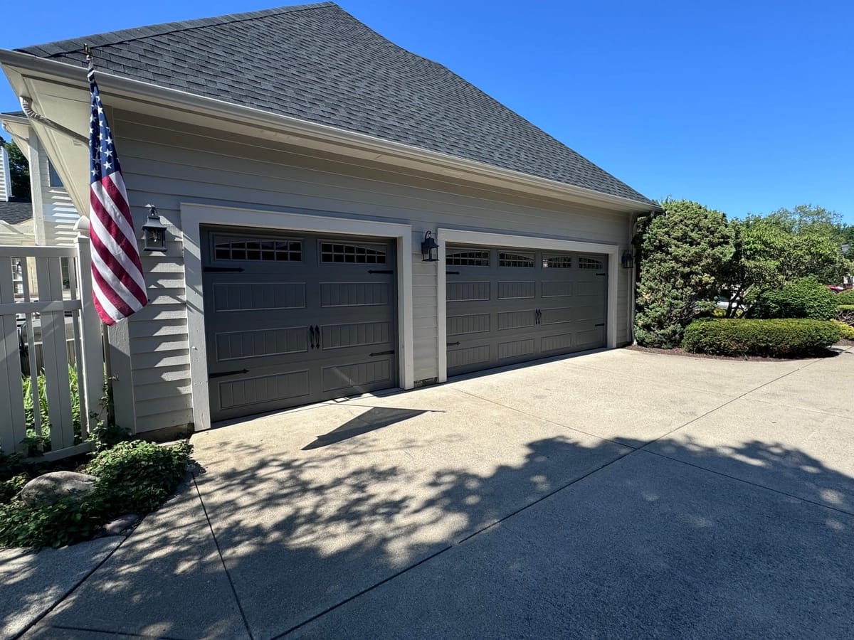 Three-car carriage-style garage doors installed by NG Overhead Garage Doors